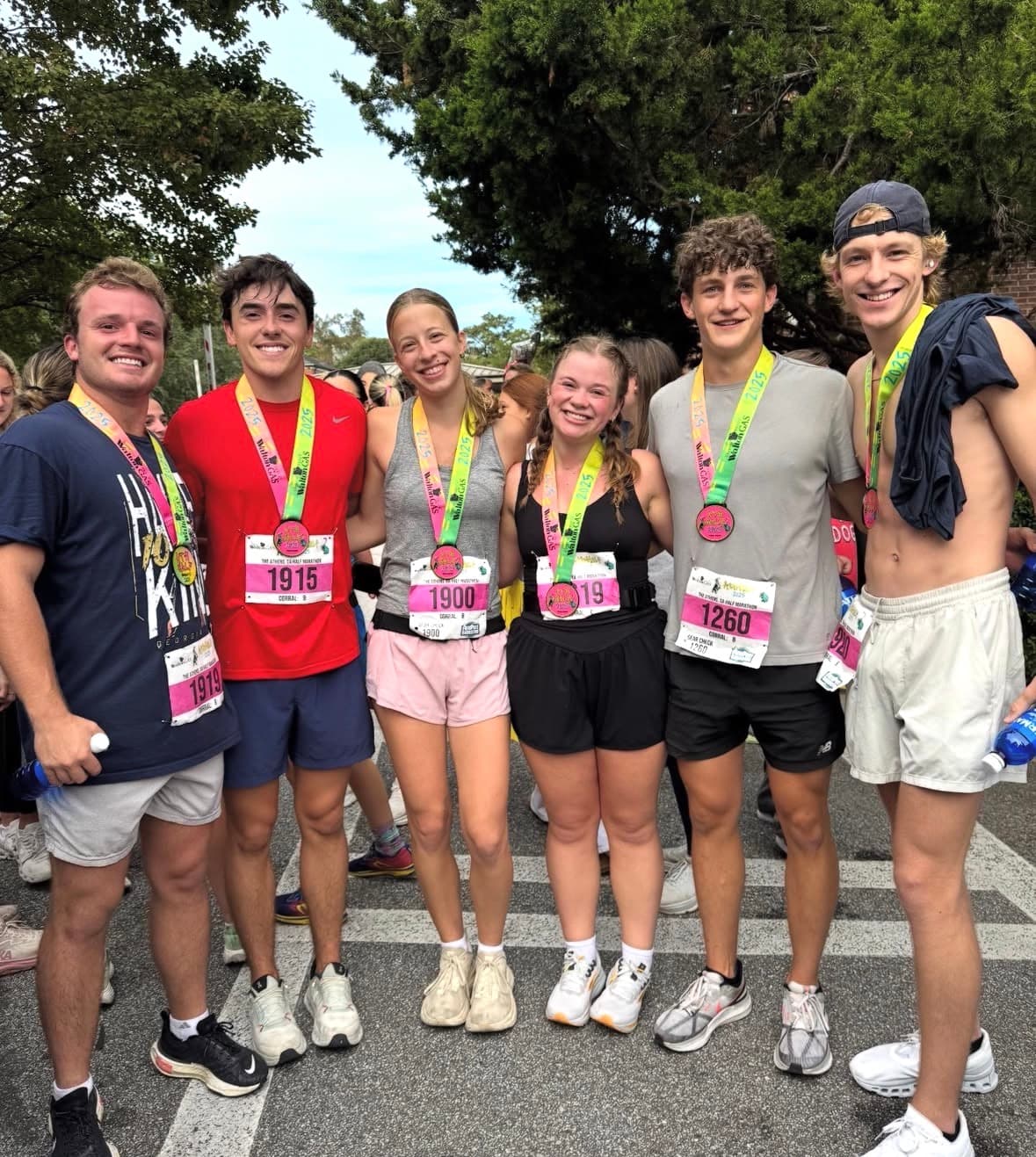 Spencer and friends wearing medals after finishing a half marathon