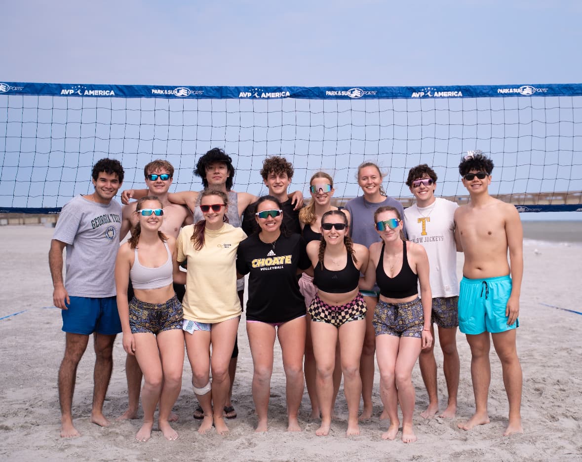 Spencer with his beach volleyball team on the sand